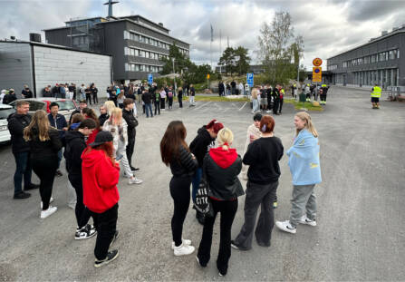 Poistumisharjoitus Raumalla. Kuvassa opiskleijoita ja henkilökuntaa odottamassa ulkona lisäohjeita.